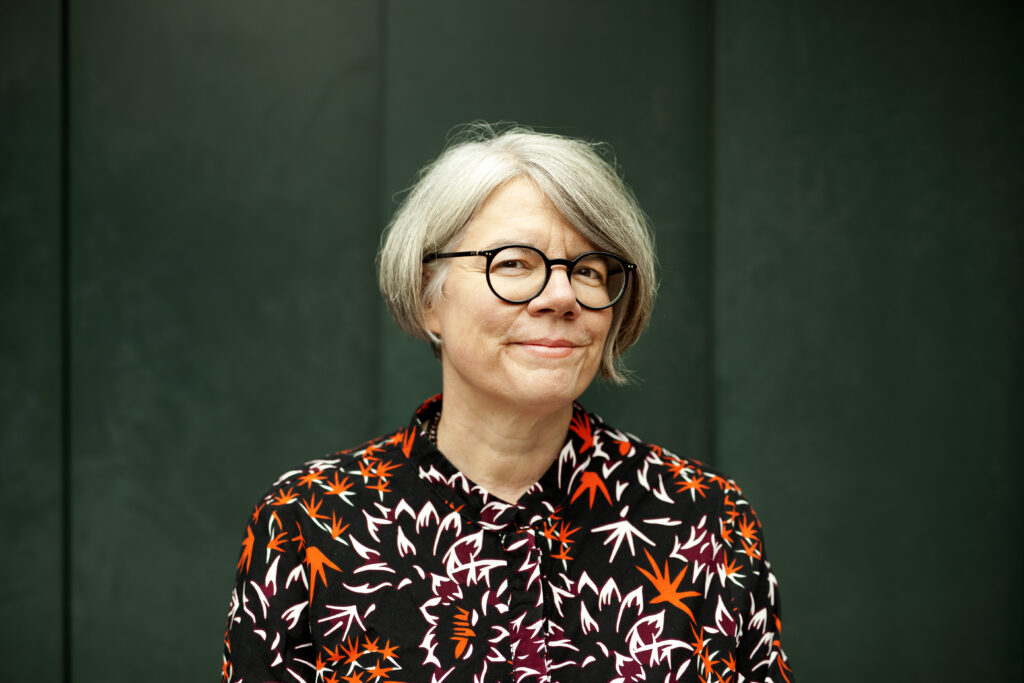 The writer Birgit Weyhe, a white woman with grey bobbed hair and black glasses